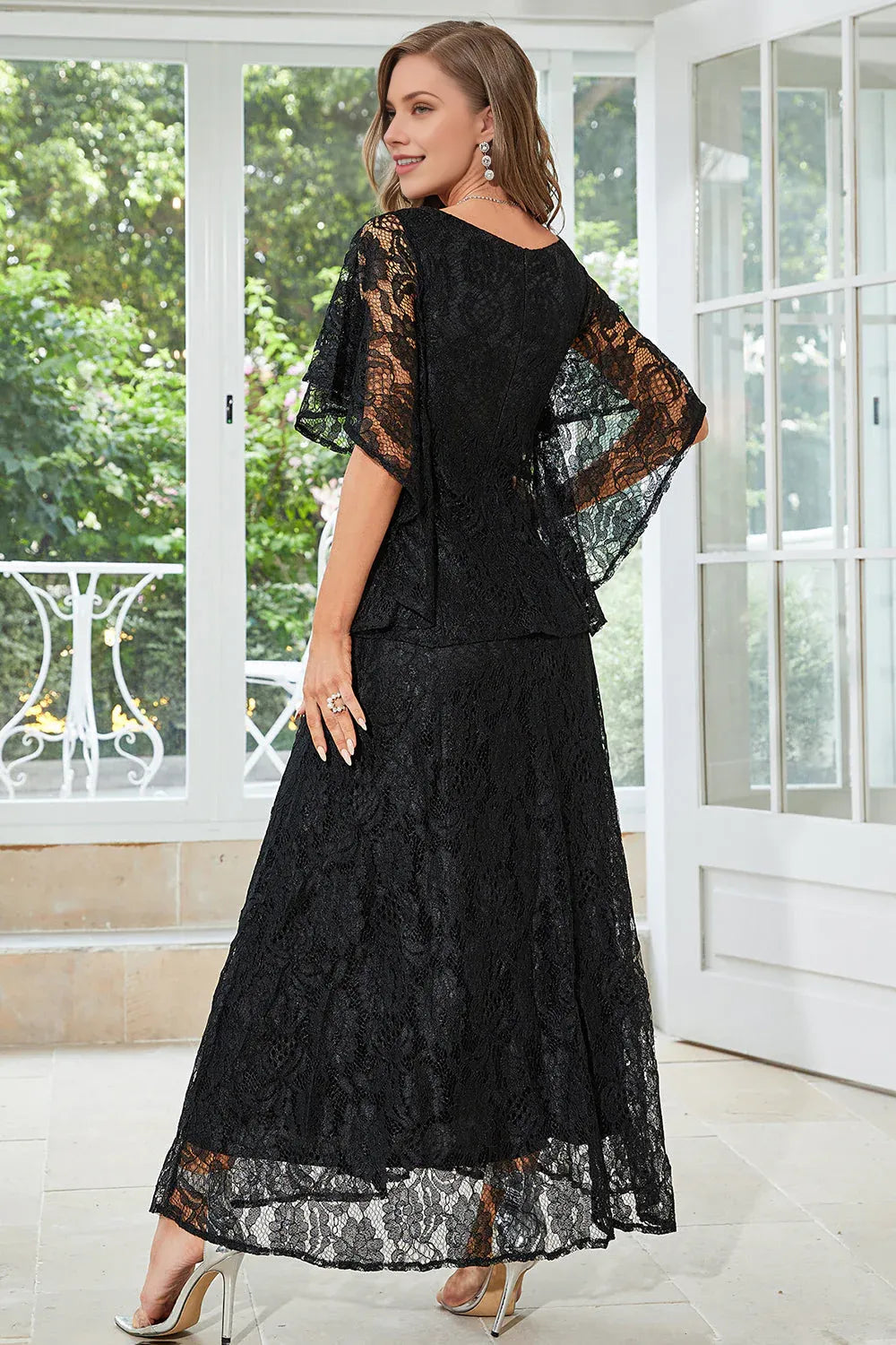 Back view of lace formal dress with flutter sleeves, rounded neckline, A-line skirt, and graceful mother of the bride styling